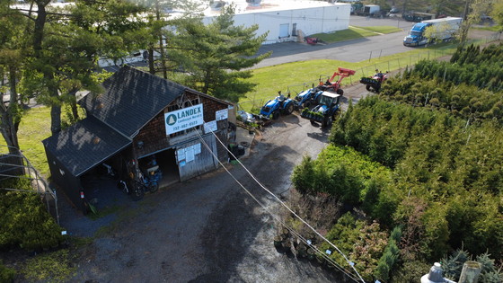 Aerial view of the Landex Nursery barn, sign and delivery tractors